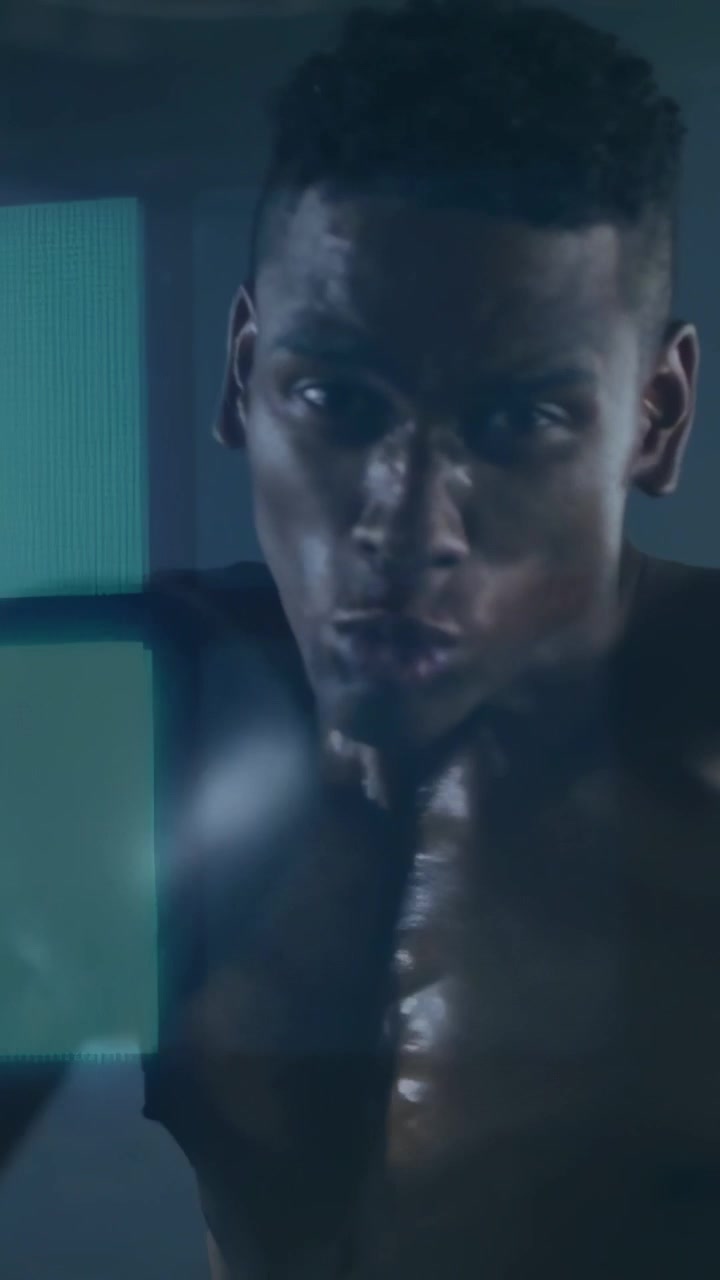 Vertical video: Camera cutting closeup, boxer training, throwing gloved jabs, teal bars shifting
