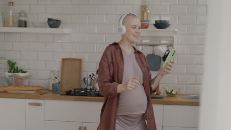 pregnant woman dancing in kitchen