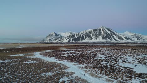 Iceland-Aerial-View-Flying-Fast-Above-Snow-Covered-Fields-In-Winter