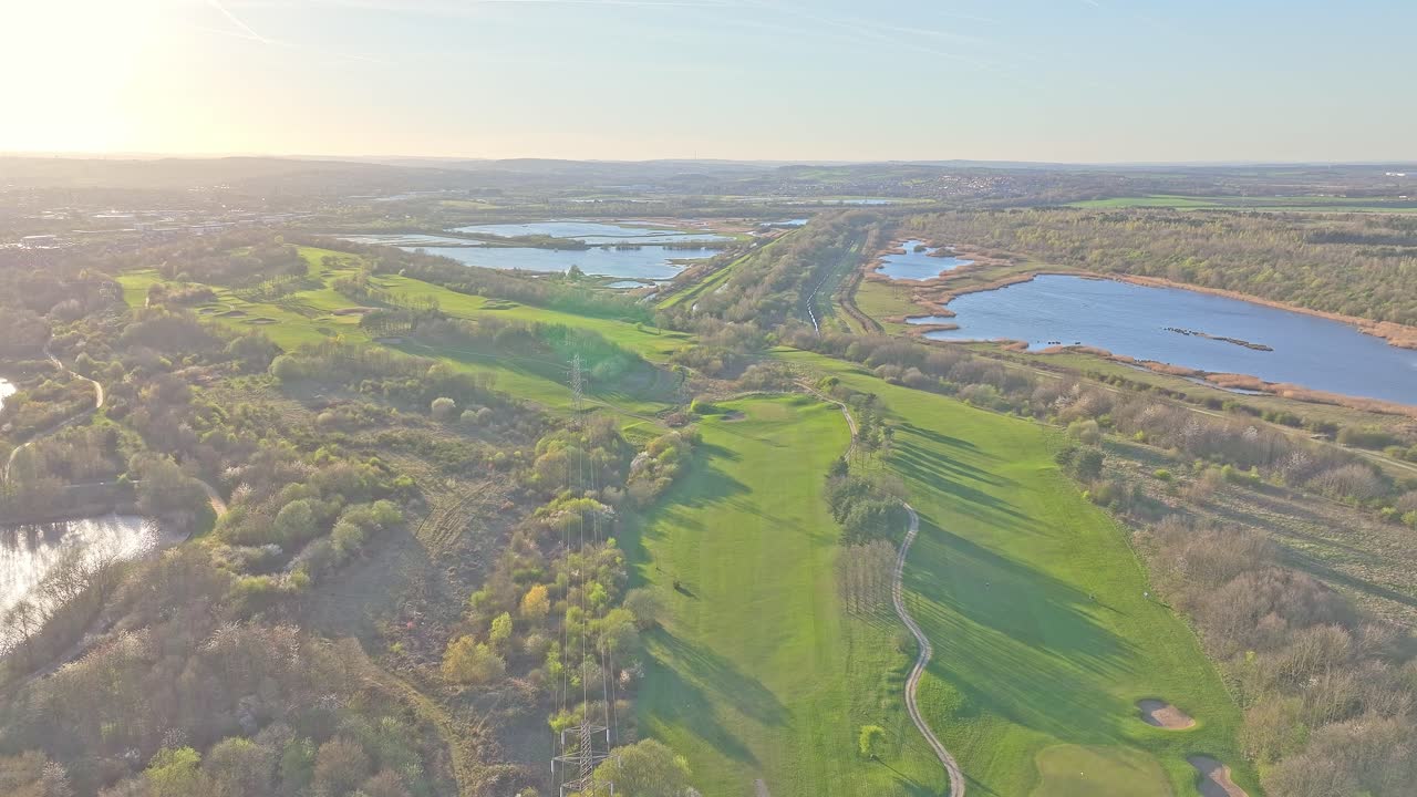 Stunning High angle view of Waterfront Golf club lush fairways and lakes under clear skies in Rotherham, South Yorkshire, UK