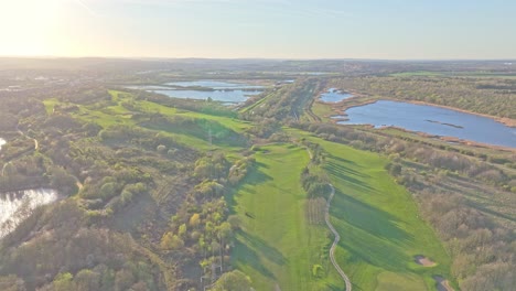 stunning high angle view of waterfront golf club lush fairways and lakes under clear skies in rotherham, south yorkshire, uk