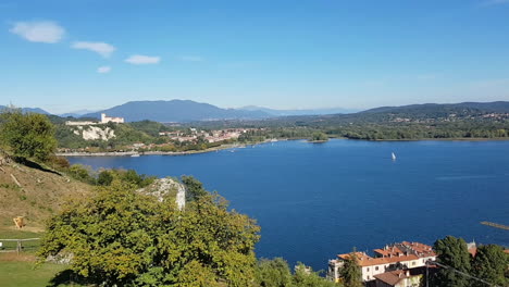 aerial view of lake maggiore from rocca of arona castle of angera in the distance and sailboat sailing