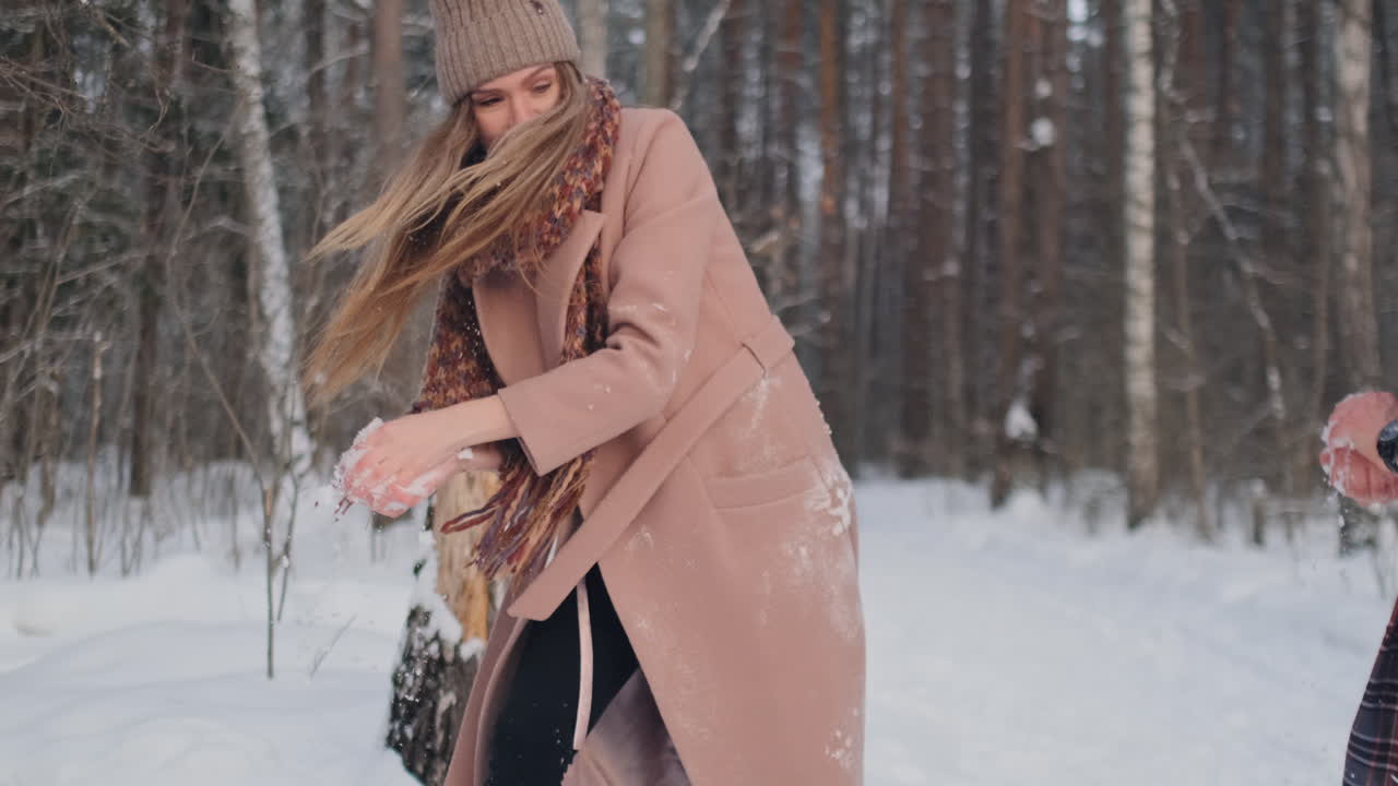 슬로우 모션-필드에서 눈싸움을 하는 커플. 그들은 하이파이브를 하며 좋은 조건으로 싸움을 끝낸다.
