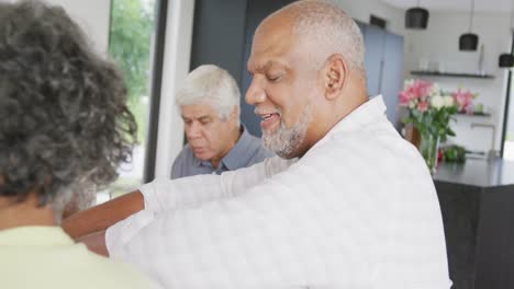 Portrait-of-happy-senior-diverse-people-having-dinner-at-retirement-home