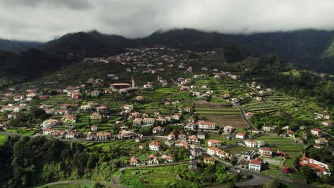 aerial shot of mountainside village on cloudy day in madeira
