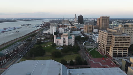 aerial view backwards over buildings in downtown baton rouge, sunset in usa