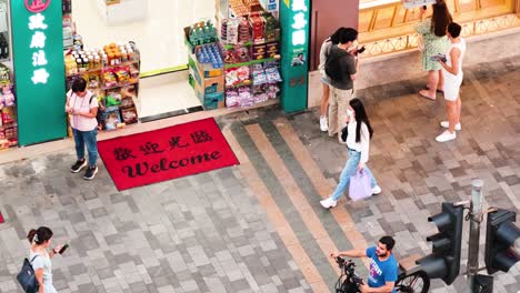 pedestrians stroll past a busy storefront