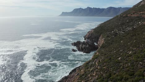 Aerial-Ocean-Coastline-Mountain-Range-on-Horizon,-Tracking-Forward-4K