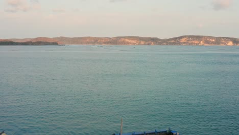 Surfing-at-sunset-at-the-surf-spot-Don-Don-in-Gerupuk,-Lombok