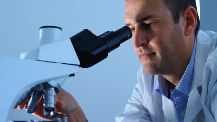 Male scientist using microscope in laboratory 4k