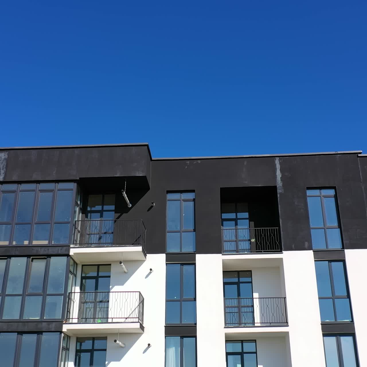 Contemporary residential building in the city. Exterior of a modern design of multistorey apartment building. Aerial view