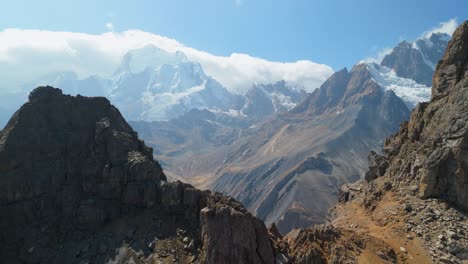 a breathtaking aerial pull-back shot reveals the immense scale of a remote mountain valley and the majestic, snow-capped peaks of the huayhuash trek in the peruvian andes