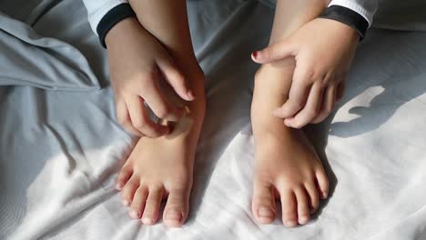 child girl suffering from itching skin, close up