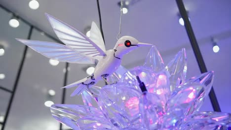 robotic hummingbird with glowing crystal flower display
