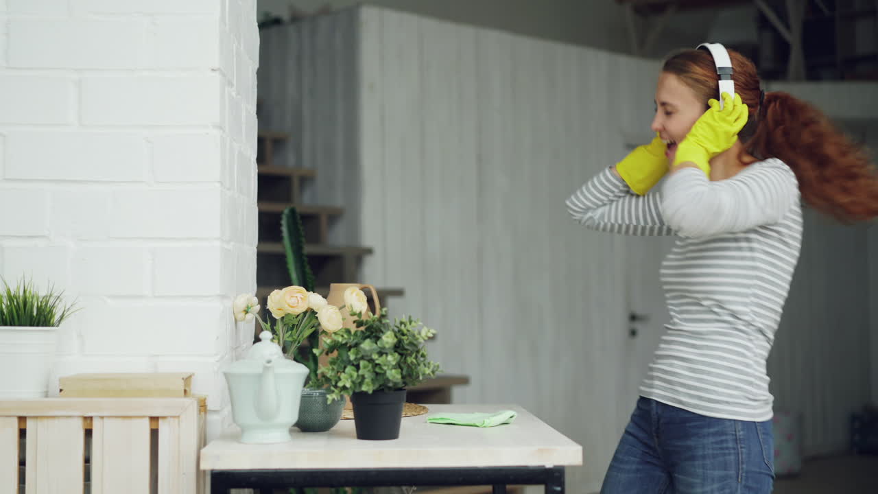 Woman Cleaning House and Dancing to Music