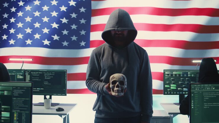 American man in a dark hood making death threats with human skull concept