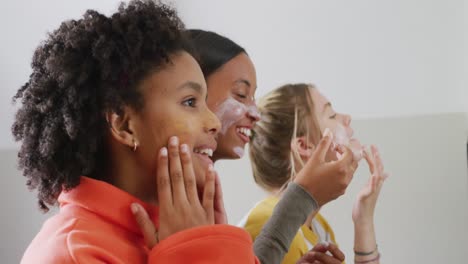 happy diverse teenager girls friends doing make up at home, slow motion