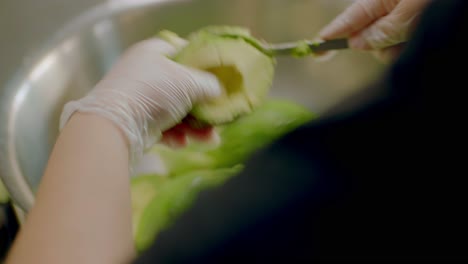 Scooping-Fresh-Avocados-into-Bowl-for-Culinary-Preparation