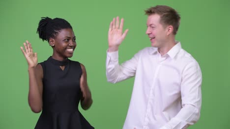 two young multi-ethnic business couple looking excited together