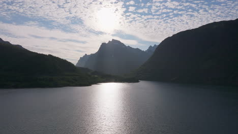 under a blue sky of cotton ball like clouds water passes through mountains