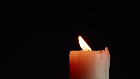 The-showcases-of-colorful-single-candlelight-on-black-background-with-the-effect-of-light-and-slow-motion