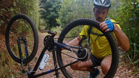 male cyclist repairing bicycle tyre