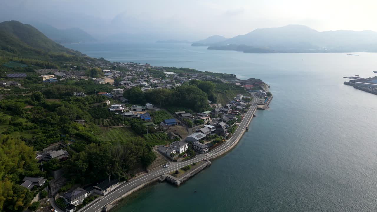 Slow motion drone tilt up over beautiful Seto Inland island scenery early in the morning