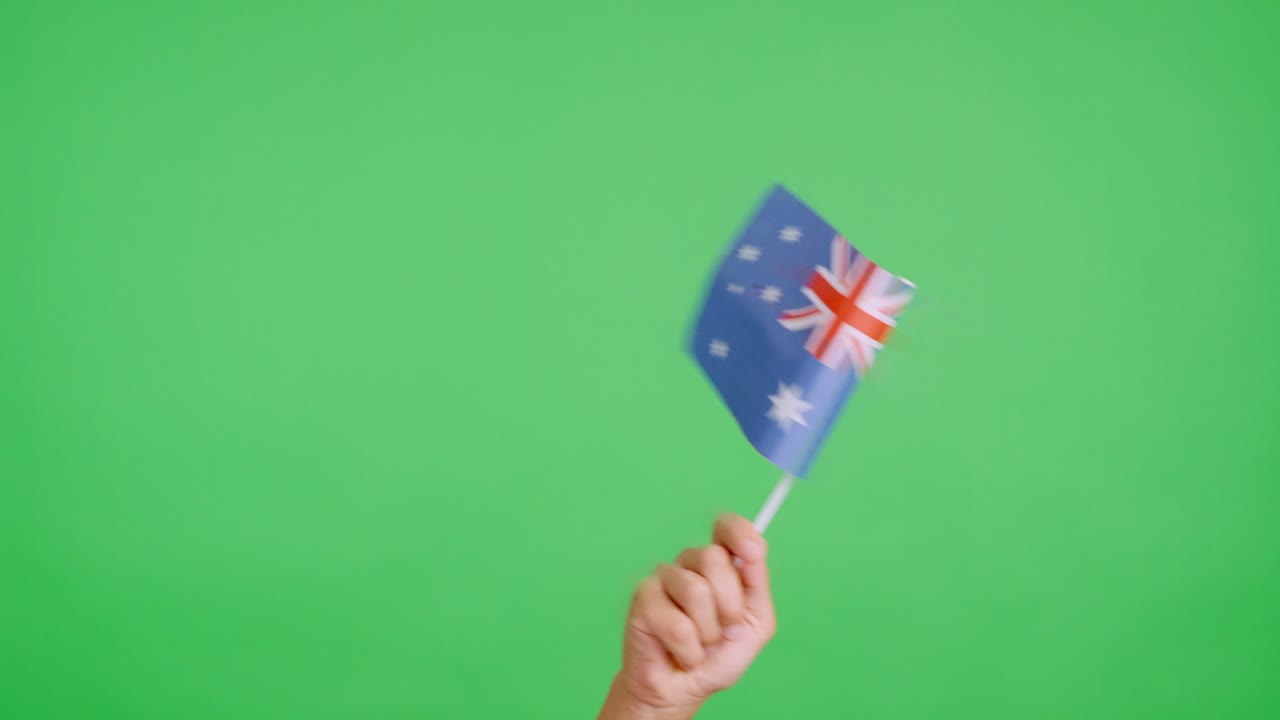 Hand waving a pennant of a australian national flag