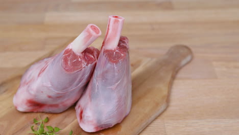 young sheep's meat - uncooked lamb chops on wooden cutting board