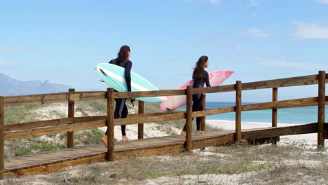 couple running with surf board 4k