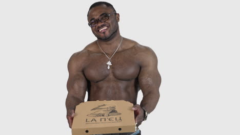 muscular man with pizza. african man holding pizza in his hands