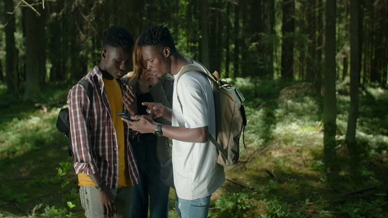 Friends Exploring the Forest with a Smartphone