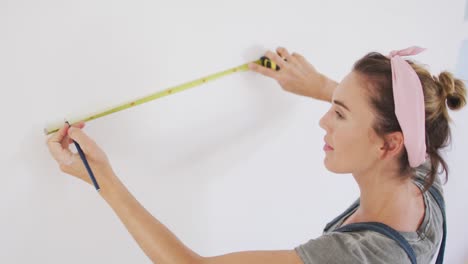 portrait of a caucasian woman in quarantine during coronavirus pandemic, doing interior work