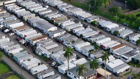 mobile home park in florida, featuring closely packed homes, palm trees, and a community center