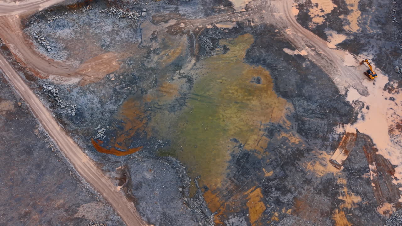 Mining area shows land and soil changes. Workers are modifying land in a mining area with machinery and large equipment