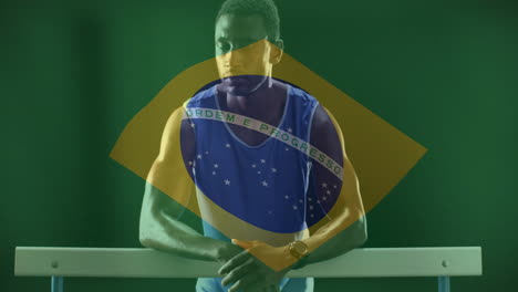 animation of flag of brazil over african american male athlete