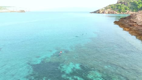 Snorkelling-along-the-shallow-reef-of-La-Ball-beach-in-Menorca,-Spain