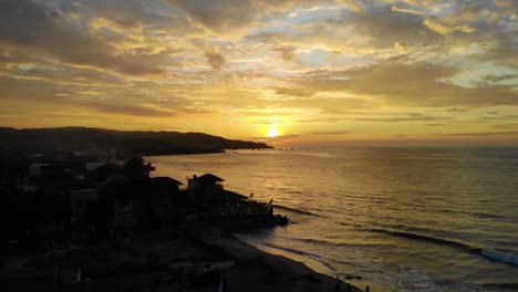 flying towards the beach at mancora during incredible sunset over ocean, peru