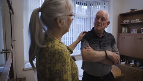 an older couple having a serious conversation at home