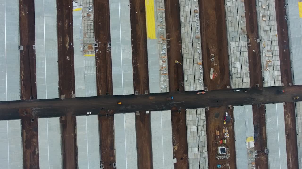 Aerial view on new buildings of future animal farm. Up to date agricultural farm in the field.