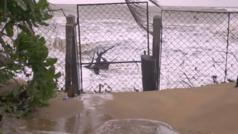 the windy storm made the seawater splashes the fences