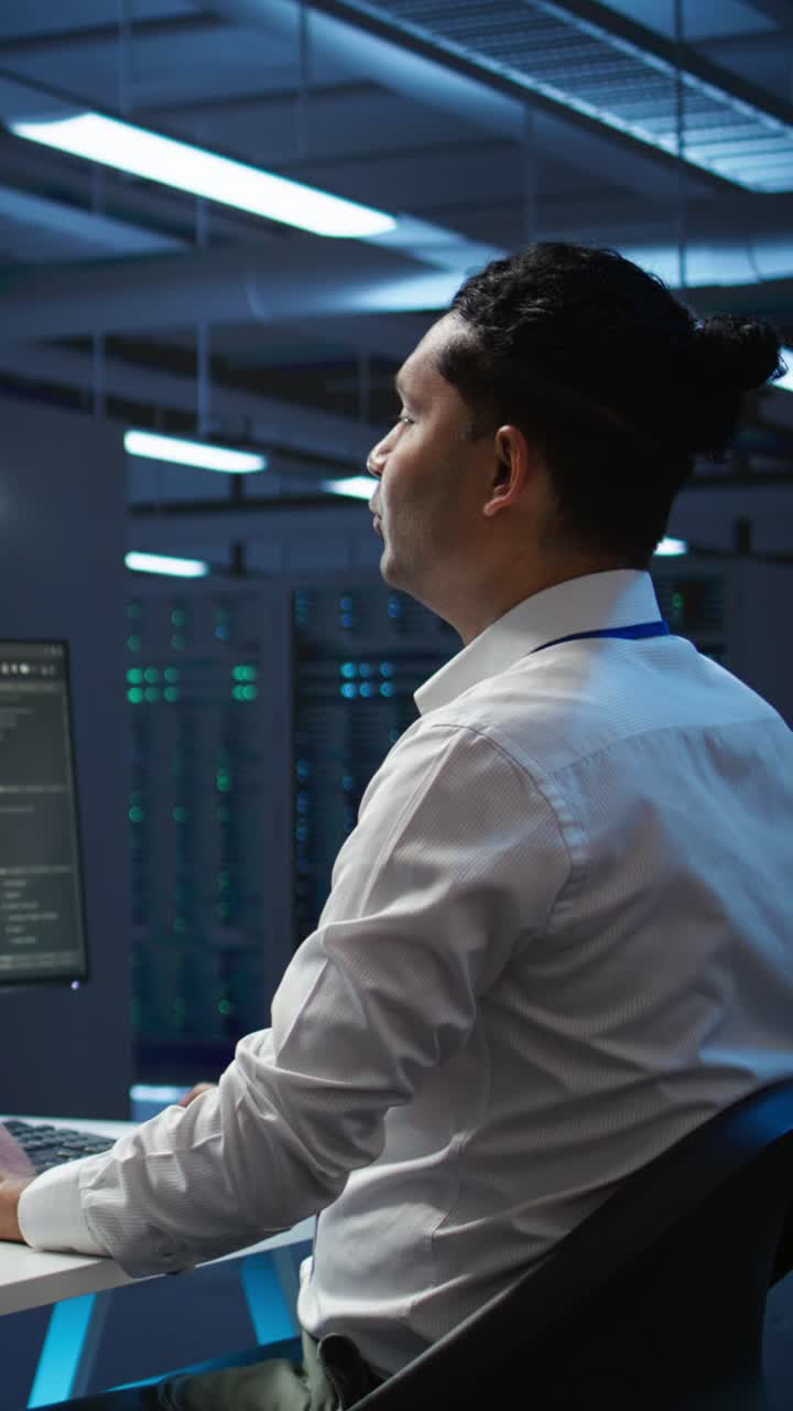 IT Engineer Working on Computer in Server Room