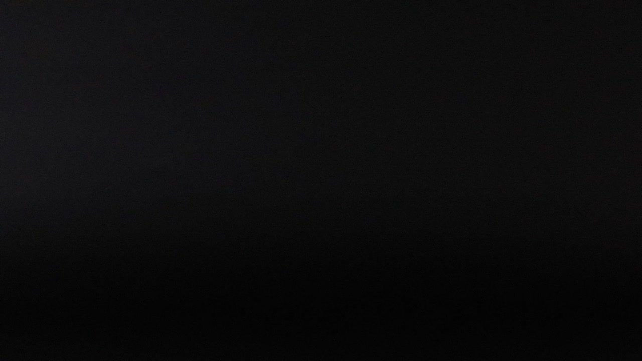 Purple Tennis Ball Against Black Background