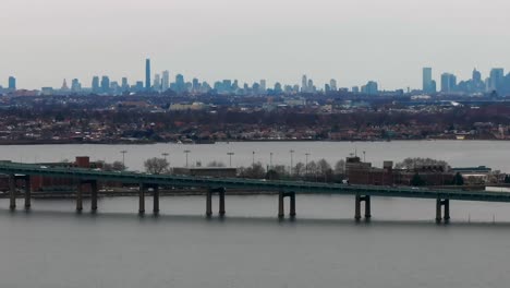 an aerial view of the throgs neck bridge elevated roadway from over the long island sound, ny on a cloudy day