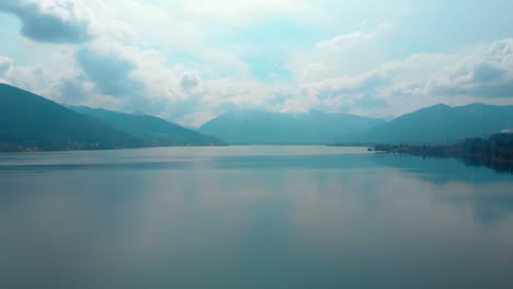 ascending aerial shot, showing the tegernsee in bavaria on a cloudy day, view towards rottach egern