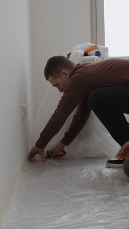 couple preparing walls for painting