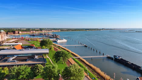panorama of lelystad, the netherlands on clear sunny day. approaching museum batavialand with a reconstruction of the ship batavia. aerial view.