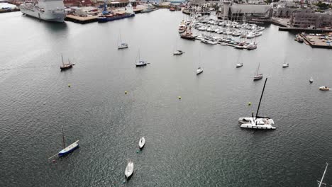 Aerial-View-Yacht-Sailing-Across-Falmouth-Harbour