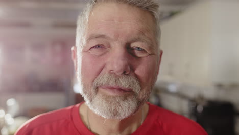 friendly face of european man with red shirt looking at camera, frontal portrait