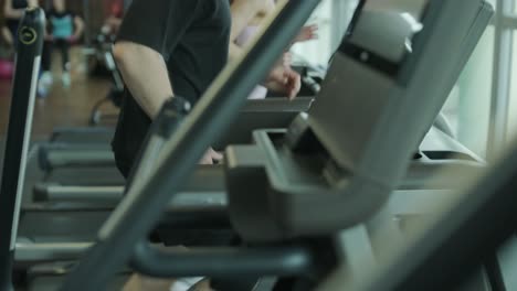 people working out on treadmills in a gym